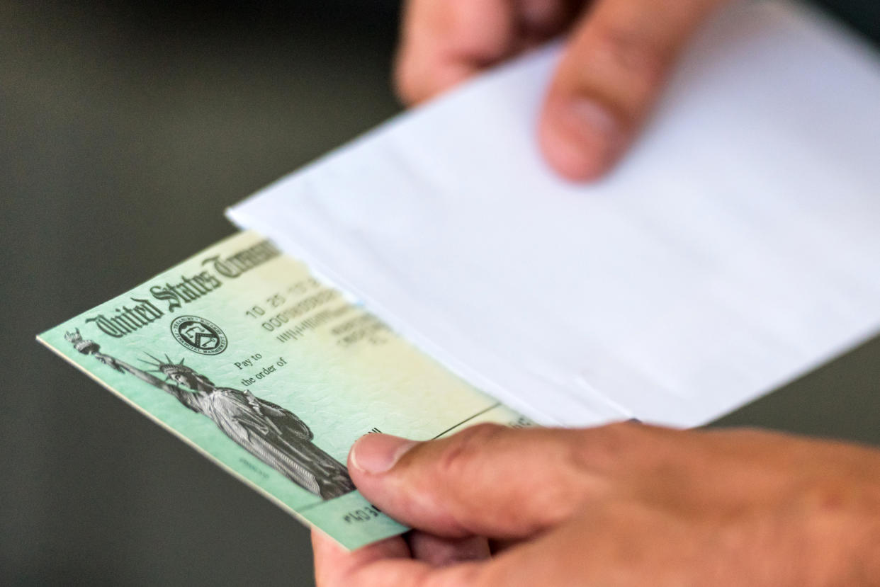 Man holds a US Government Treasury check.