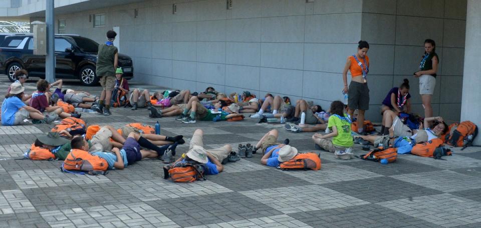 Attendees of the World Scout Jamboree lie down to rest at a scout camping site in Buan, South Korea (Kim-yeol/Newsis via AP)