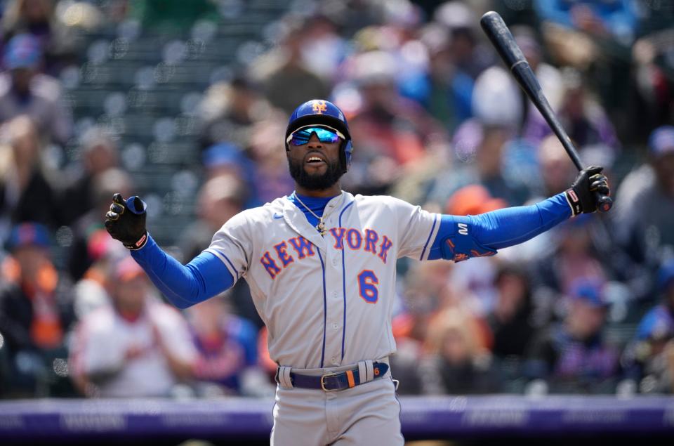 New York Mets' Starling Marte reacts after swinging at and missing a pitch from Colorado Rockies starter German Marquez in the sixth inning of the first baseball game game of a day/night doubleheader Saturday, May 21 2022, in Denver.