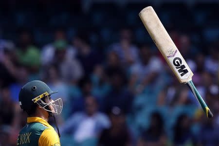 South Africa's Quinton de Kock throws his bat as he walks off the field after being dismissed by West Indies bowler Jason Holder for twelve runs during the Cricket World Cup match at the Sydney Cricket Ground (SCG) February 27, 2015. REUTERS/Jason Reed