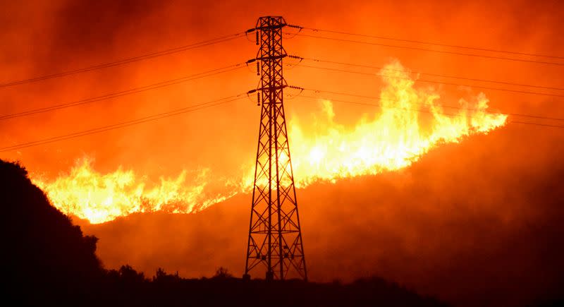 FILE PHOTO: Firefighters battle a wind-driven wildfire in Sylmar, California