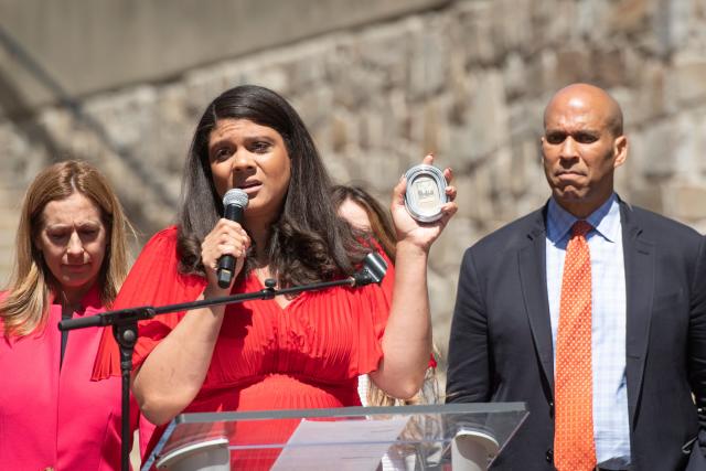 N.J. Assemblywoman Britnee Timberlake holds up a photo, which she keeps in her office, of her great-aunt, who she said died from an illegally performed abortion years ago. A pro-Roe rally brought lawmakers and abortion rights activists to the Rutgers-Newark campus on Monday. May 9, 2022.