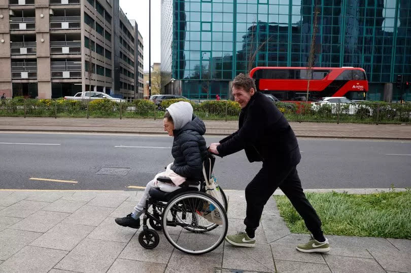 Shane pushing Annmarie in a wheelchair through Croydon town centre