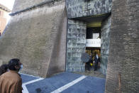 The first visitors of the day enter the Vatican Museums, at the Vatican, Monday, Feb. 1, 2021. The Vatican Museums reopened Monday to visitors after 88 days of shutdown following COVID-19 containment measures. (AP Photo/Andrew Medichini)