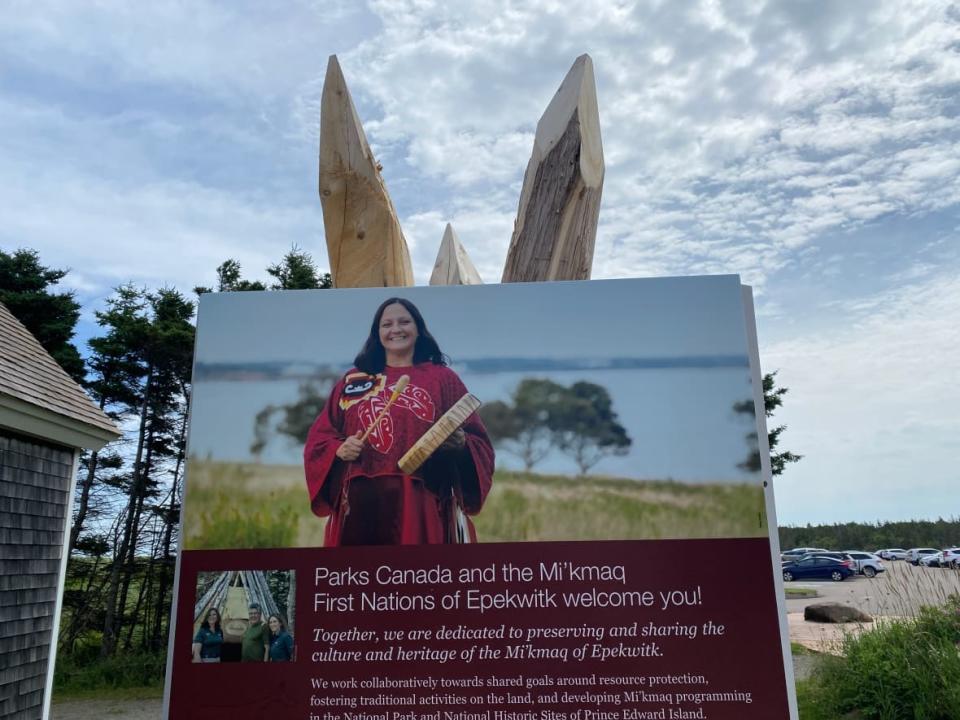 A sign at P.E.I. National Park, featuring P.E.I.'s first Indigenous poet laureate Julie Pellissier-Lush, welcomes visitors to Brackley Beach. (Jane Robertson/CBC - image credit)