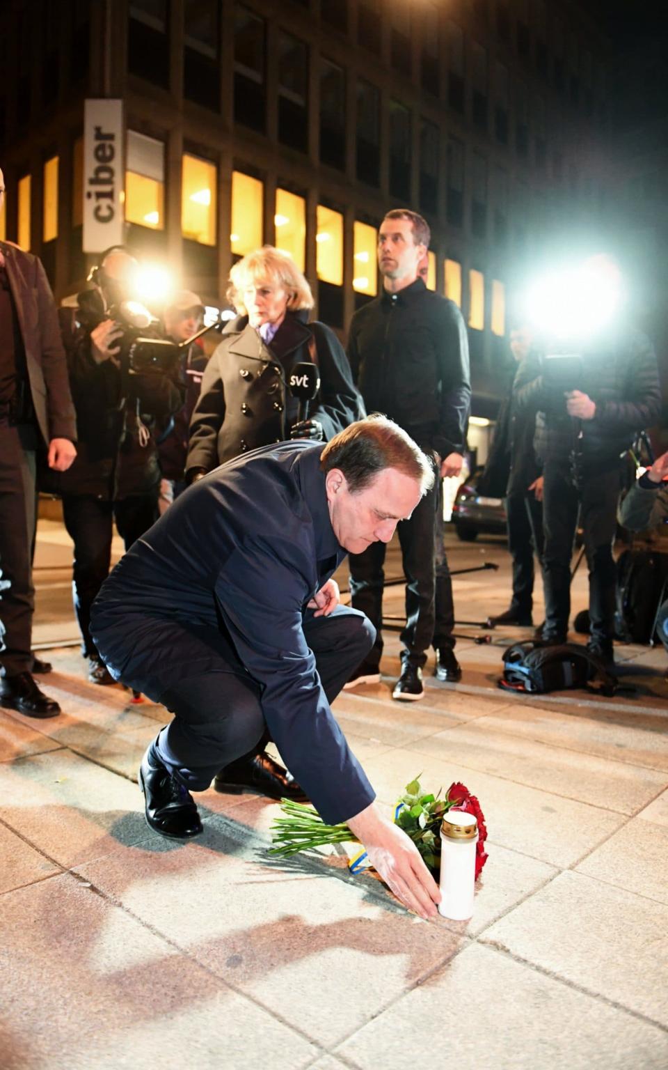 Sweden's Prime Minister Stefan Lofven place flowers at Queens Street after the terror attack on Drottninggatan - Credit: Fredrik Sandberg/TT