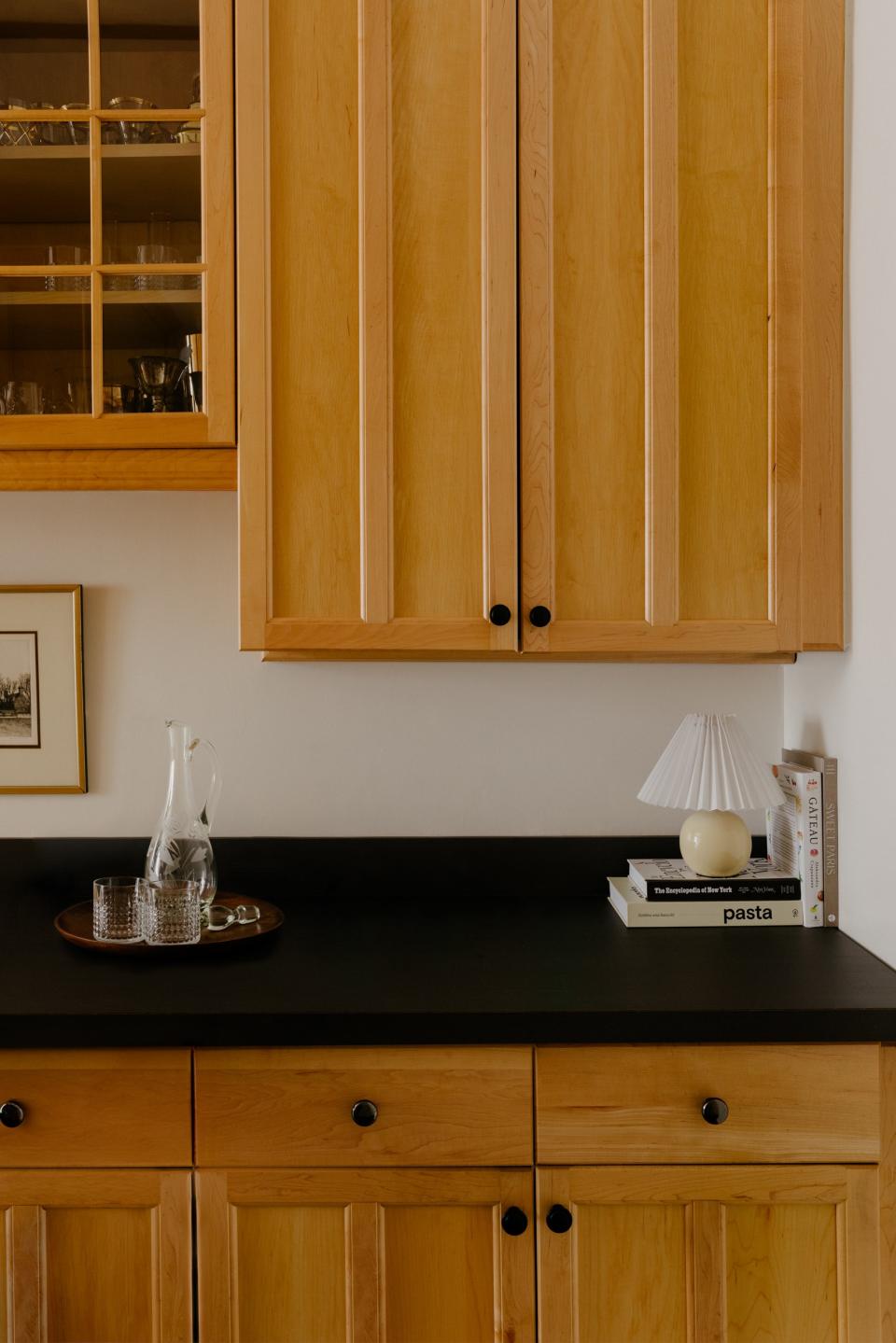 Justin plans to update the existing kitchen in the next 5 to 10 years, but the dated wood cabinets will have to do for now.