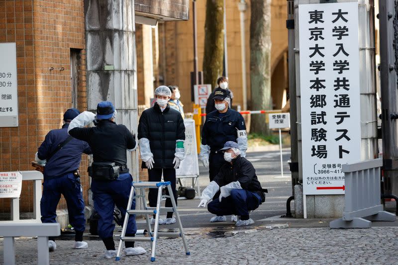 Police officers inspect the site where a stabbing incident happened at an entrance gate of Tokyo University in Tokyo