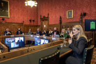 In this handout photo provided by UK Parliament, Facebook whistleblower Frances Haugen, right, gives evidence to the joint committee for the Draft Online Safety Bill, as part of government plans for social media regulation, in London, Monday, Oct. 25, 2021. Haugen said Monday that Facebook is making online hate and extremism worse and outlined how it could improve online safety. (Annabel Moeller/UK Parliament via AP)