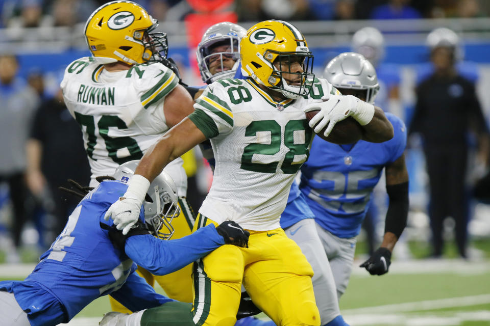 Green Bay Packers running back A.J. Dillon (28) rushes during the second half of an NFL football game against the Detroit Lions, Sunday, Jan. 9, 2022, in Detroit. (AP Photo/Duane Burleson)