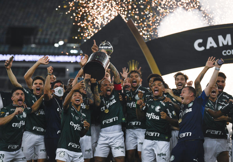 Players of Brazil's Palmeiras celebrate with the trophy after winning the Copa Libertadores final soccer match against Brazil's Santos at the Maracana stadium in Rio de Janeiro, Brazil, Saturday, Jan. 30, 2021. Palmeiras won 1-0.(Mauro Pimentel/Pool via AP)