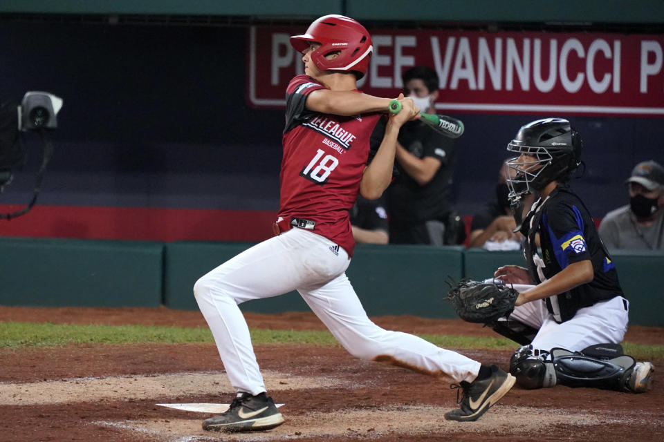 Hamilton, Ohio's Chance Retherford follows through on a two-run triple off Torrance, Calif.'s Dominic Golia during the fifth inning of a baseball game at the Little League World Series in South Williamsport, Pa., Thursday, Aug. 26, 2021. Ohio won 4-2. (AP Photo/Gene J. Puskar)
