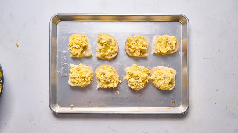 egg breakfast sandwiches in assembly on sheet tray