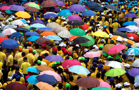 People stand while waiting for a coronation procession for Thailand's newly crowned King Maha Vajiralongkorn in Bangkok, Thailand May 5, 2019. REUTERS/Navesh Chitrakar