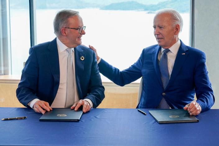 President Joe Biden, right, gestures to Australia&#39;s Prime Minister Anthony Albanese following a document signing ceremony on the sidelines of the G7 Summit in Hiroshima, Japan, Saturday, May 20, 2023.