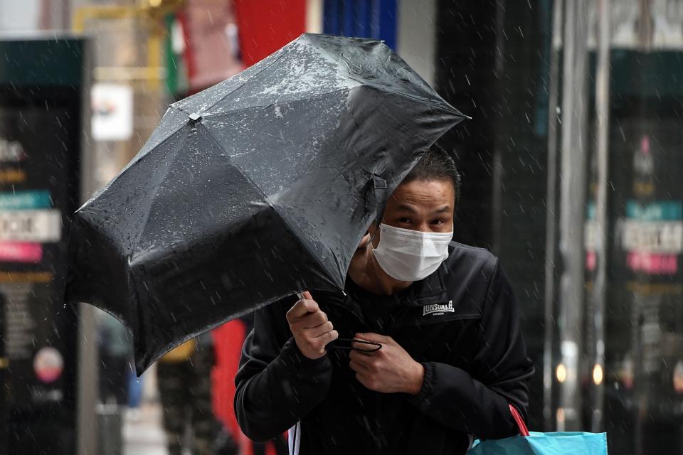 A pedestrian struggles against the wind in Glasgow city centre  (AFP via Getty Images)