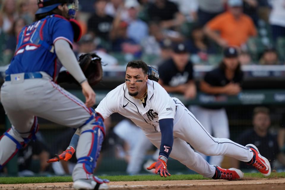 Detroit Tigers'  Javier Baez begins his slide to score during the third inning of a game against the Texas Rangers at Comerica Park in Detroit on Tuesday, May 30, 2023.