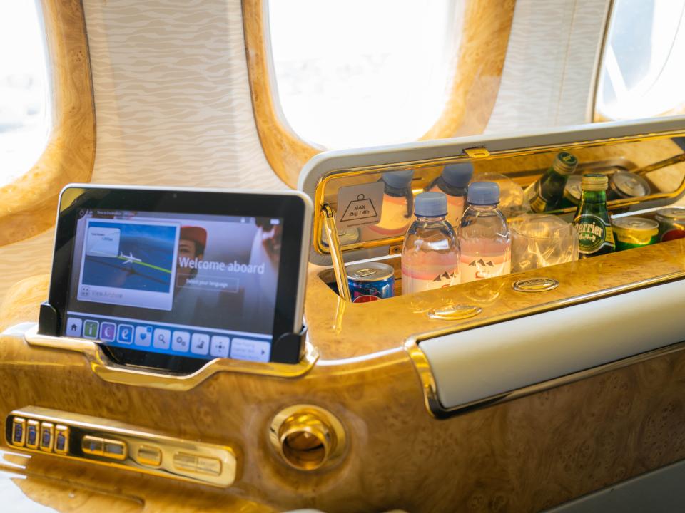 Tablet and bottles of water by airplane windows