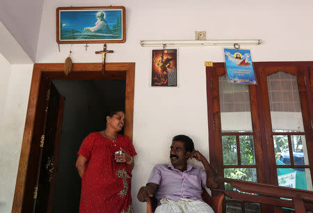 Farmer, Joby Pathrose speaks to his wife Kavitha at their house in Okkal Village in Ernakulam, Kerala, India, September 25, 2018. REUTERS/Sivaram V