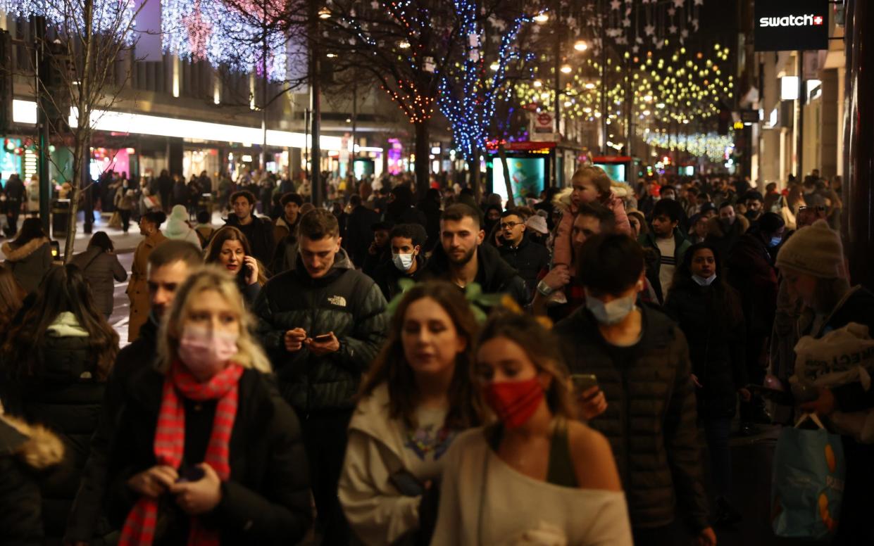 Shoppers walk along Oxford Street on December 27, 2021 in London, England. Retailers have seen a decrease in footfall amid a recent surge in COVID-19 cases across the UK due to the Omicron variant. - Hollie Adams /Getty Images Europe 