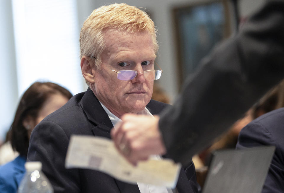 Alex Murdaugh looks over evidence of a check brought to him and his attorneys during his double murder trial at the Colleton County Courthouse on Tuesday, Feb. 7, 2023, in Walterboro, S.C. The 54-year-old attorney is standing trial on two counts of murder in the shootings of his wife and son at their Colleton County home and hunting lodge on June 7, 2021. (Andrew J. Whitaker/The Post And Courier via AP, Pool)/The Post And Courier via AP, Pool)