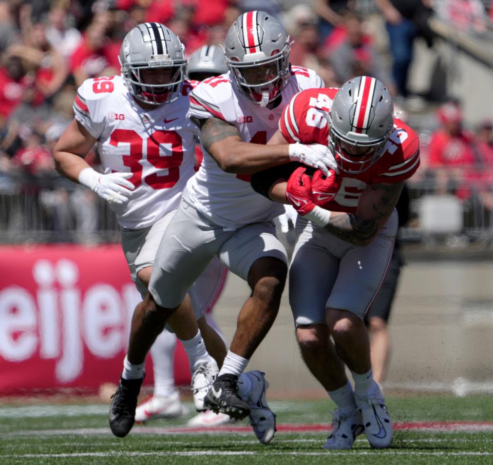 April 13, 2024; Columbus, Ohio, USA; 
Ohio State Buckeyes Jace Middleton (46) runs the ball for the scarlet team while pursued by linebacker C.J. Hicks (11) of the grey team during the second half of the LifeSports spring football game at Ohio Stadium on Saturday.