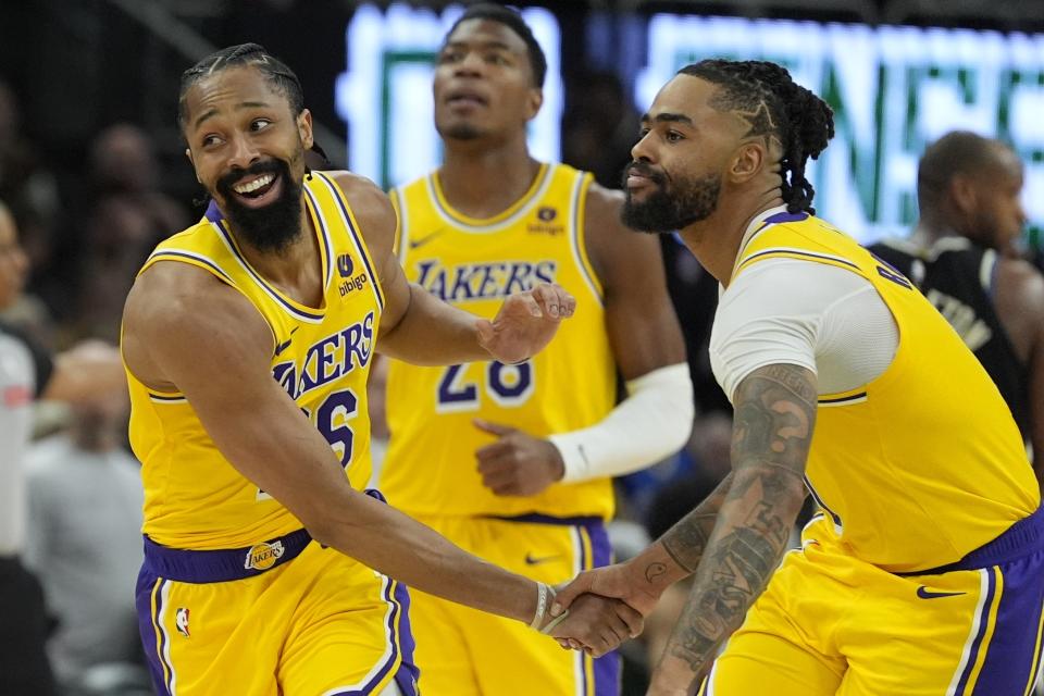 Los Angeles Lakers' Spencer Dinwiddie and D'Angelo Russell celebrate during overtime of an NBA basketball game against the Milwaukee Bucks Tuesday, March 26, 2024, in Milwaukee. The Lakers won 128-124 in double overtime. (AP Photo/Morry Gash)