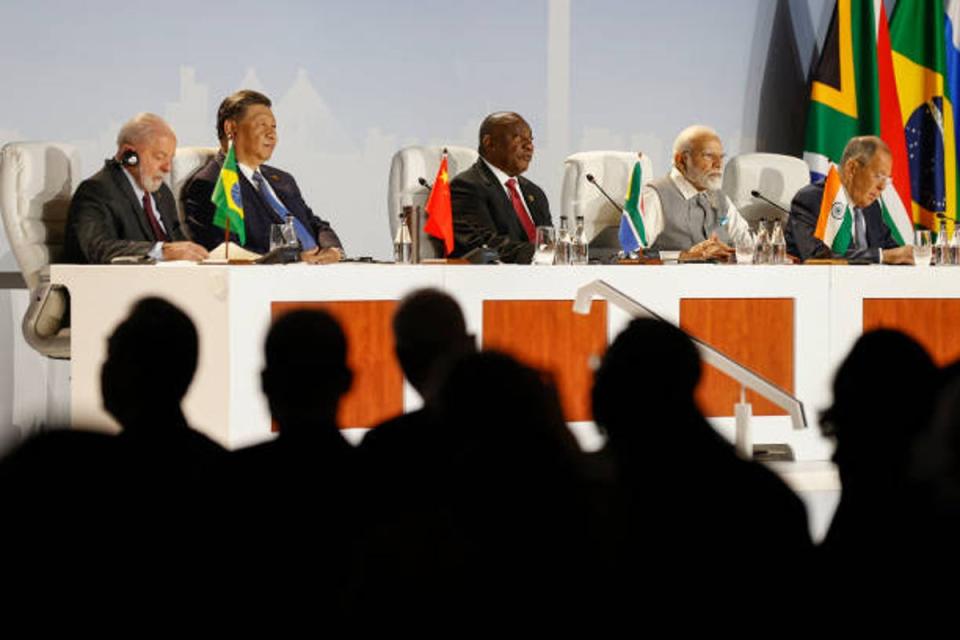 President of China Xi Jinping, president of Brazil Luiz Inacio Lula da Silva, South African president Cyril Ramaphosa and prime minister of India Narendra Modi gesture during the 2023 Brics Summit at the Sandton Convention Centre in Johannesburg on 24 August 2023 (AFP via Getty Images)