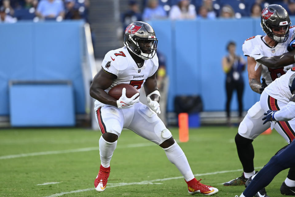 FILE - Tampa Bay Buccaneers running back Leonard Fournette (7) carries the ball against the Tennessee Titans in the first half of a preseason NFL football game Saturday, Aug. 20, 2022, in Nashville, Tenn. When Tom Brady announced he was ending his brief retirement and returning to the NFL for a 23rd season, Fournette wasn’t caught off guard. Brady, who turned 45 a week into training camp, cited “unfinished business” as one of the reasons for changing his mind. (AP Photo/Mark Zaleski, File)