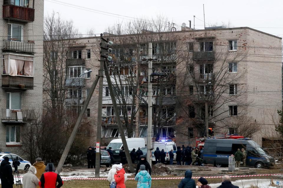 Russian emergency servicemen and investigators work near a damaged multi-storey residential building (EPA)