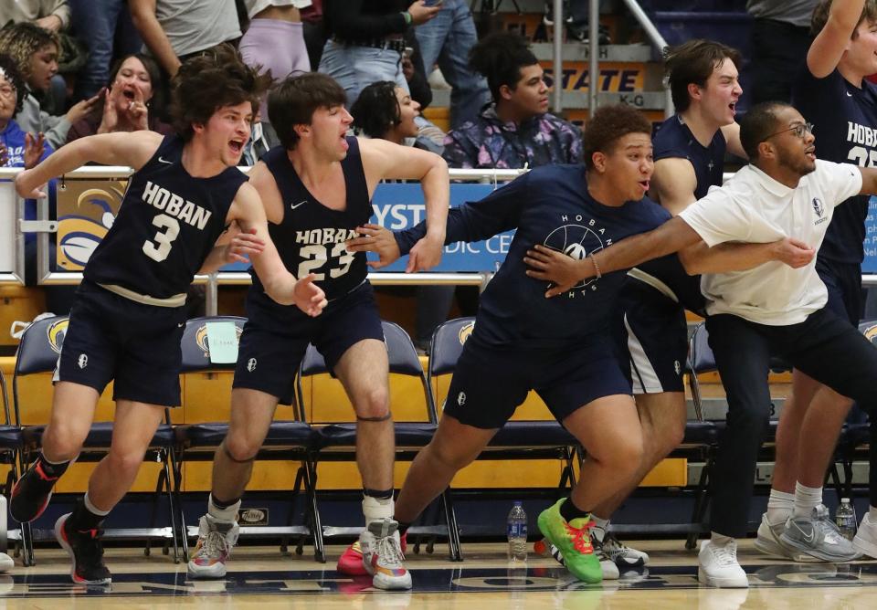The Hoban bench erupts as the clock winds down in a regional semifinal win over St. Edward, Tuesday, March 7, in Kent.