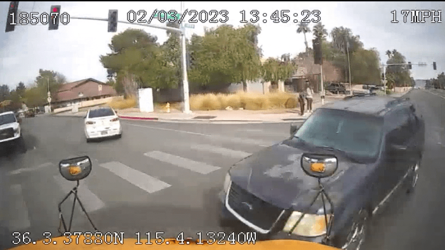 <em>Video provided to 8 News Now apparently shows a school bus driving past a yellow light in Henderson, hitting a black SUV. The vehicle’s driver and passenger were injured in the crash. The head-on crash that happened on Feb 3, 2023, at the intersection of Valle Verde Drive and Warm Springs Avenue, sparked a lawsuit that was filed last week against CCSD.</em> (CCSD)