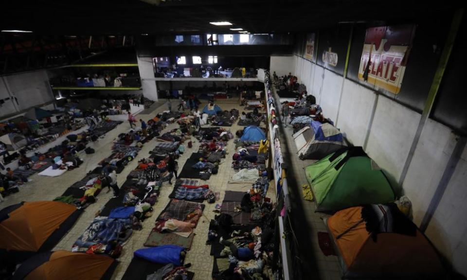 Migrants begin their day inside a former concert venue serving as a shelter, in Tijuana, Mexico. 