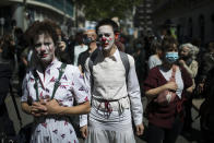 Performers march at a demonstration in Marseille, southern France, Friday, April 23, 2021. Performers and cultural workers who have been left professionally idle due to restrictive lockdown measures took to the streets across France to protest a new unemployment benefits reform. (AP Photo/Daniel Cole)