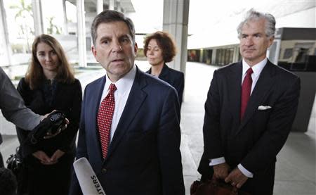 Attorney Aaron Marcu (2nd L) speaks about his client, Raoul Weil, a former high-ranking UBS banker charged with tax fraud by U.S. authorities, who is pending release on bail of $10.5 million at federal court in Fort Lauderdale, Florida December 16, 2013. From left behind are attorney Kimberly Zelnick, Susan Lerch Weil, wife of Raoul Weil, and attorney David Mandel. REUTERS/Joe Skipper