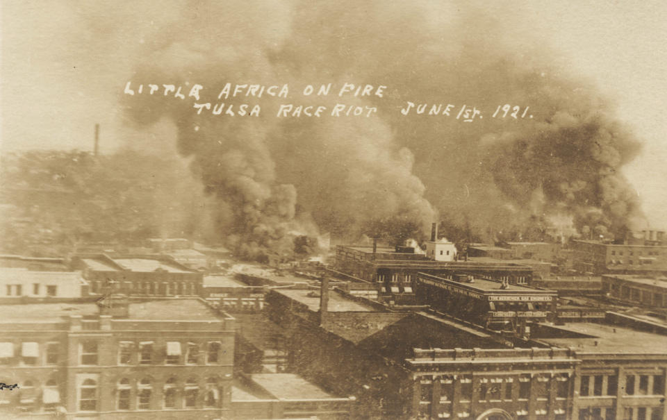 This postcard provided by the Department of Special Collections, McFarlin Library, The University of Tulsa shows fires burning during the Tulsa Race Massacre in Tulsa, Okla. on June 1, 1921. (Department of Special Collections, McFarlin Library, The University of Tulsa via AP)