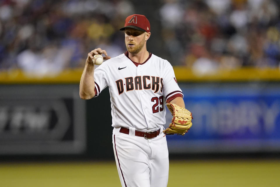 Arizona Diamondbacks starting pitcher Merrill Kelly (29) throws the ball downward after giving up a run against the Los Angeles Dodgers during the fifth inning of a baseball game, Monday, April 25, 2022, in Phoenix. (AP Photo/Matt York)