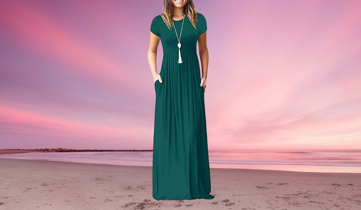 The lower body of a woman wearing a long green maxi dress, short sleeves