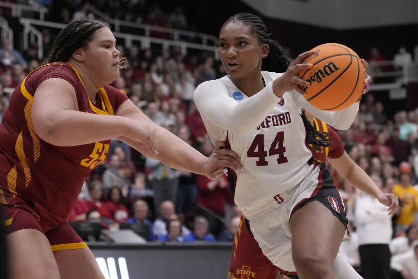 Stanford forward Kiki Iriafen (44) drives to the basket against Iowa State center Audi Crooks.