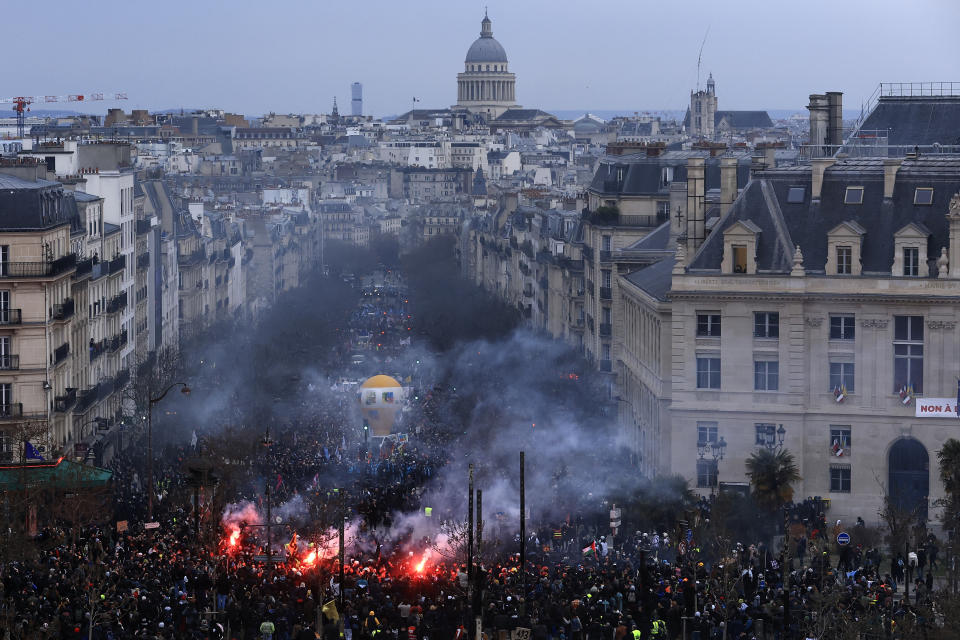 FILE - Protesters march, with the Pantheon monument in background, during a demonstration in Paris, on March 7, 2023. French President Emmanuel Macron has ignited a firestorm of anger with unpopular pension reforms that he rammed through parliament. Young people, some of them first-time demonstrators, are joining protests against him. Violence is also picking up. (AP Photo/Aurelien Morissard, File)