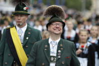 <p>A man wears a hat with the traditional decoration ‘Gamsbart’ (beard of chamois). (AP Photo/Matthias Schrader) </p>