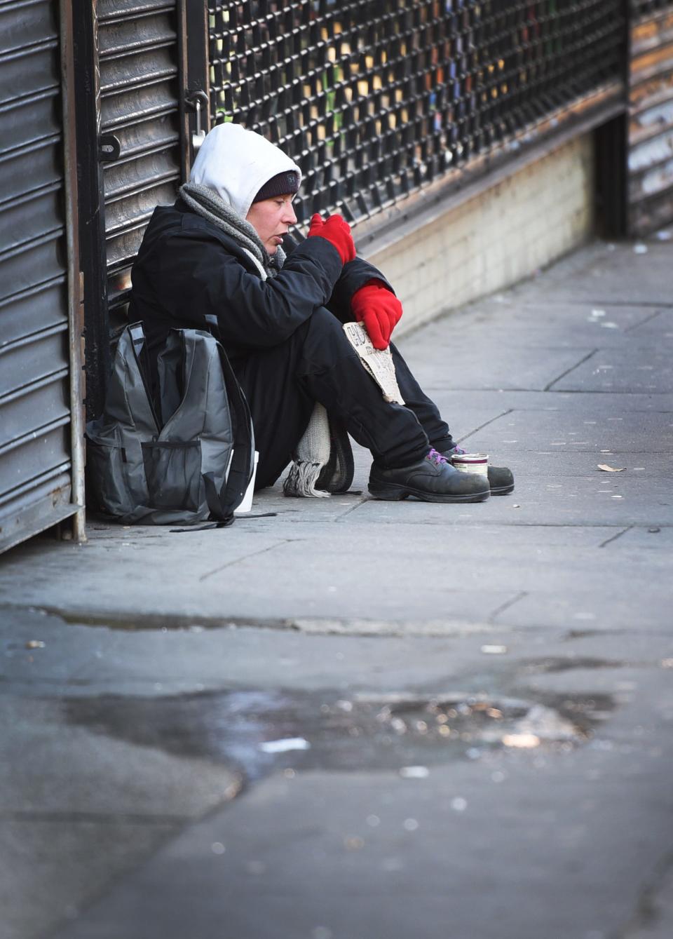 A homeless woman, Irene (age 36) of Paterson, who has been homeless for a year and a half, panhandles near the corner of Main and Market Streets in downtown Paterson, NJ., on 01/30/19. 