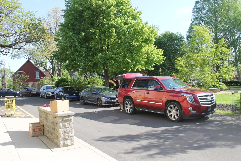 Cars wait in line to pick up food from the Broad Street Presbyterian Church food bank on May 9, 2022.