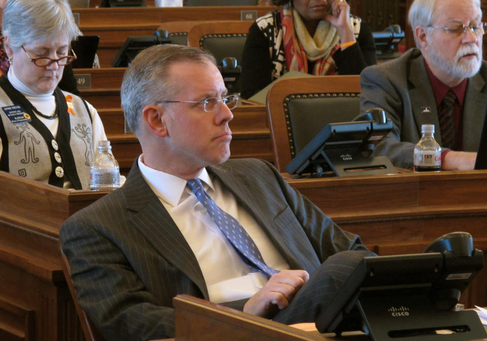 In this photo from Tuesday, Feb. 11, 2014, Kansas House Minority Leader Paul Davis, a Lawrence Democrat, listens to a debate on marriage legislation opposed by gay-rights advocates, at the Statehouse in Topeka, Kan. Davis is running for governor and is being criticized for not being strong enough in his opposition to the bill. (AP Photo/John Hanna)