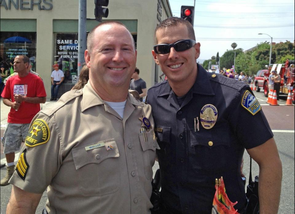 Los Angeles County Sheriff's Sergeant Don Mueller and LAX Airport Police Officer David Ayala celebrate pride as they prepare to march with over 60 other openly gay officers in the 2012 West Hollywood CSW Pride Parade.   