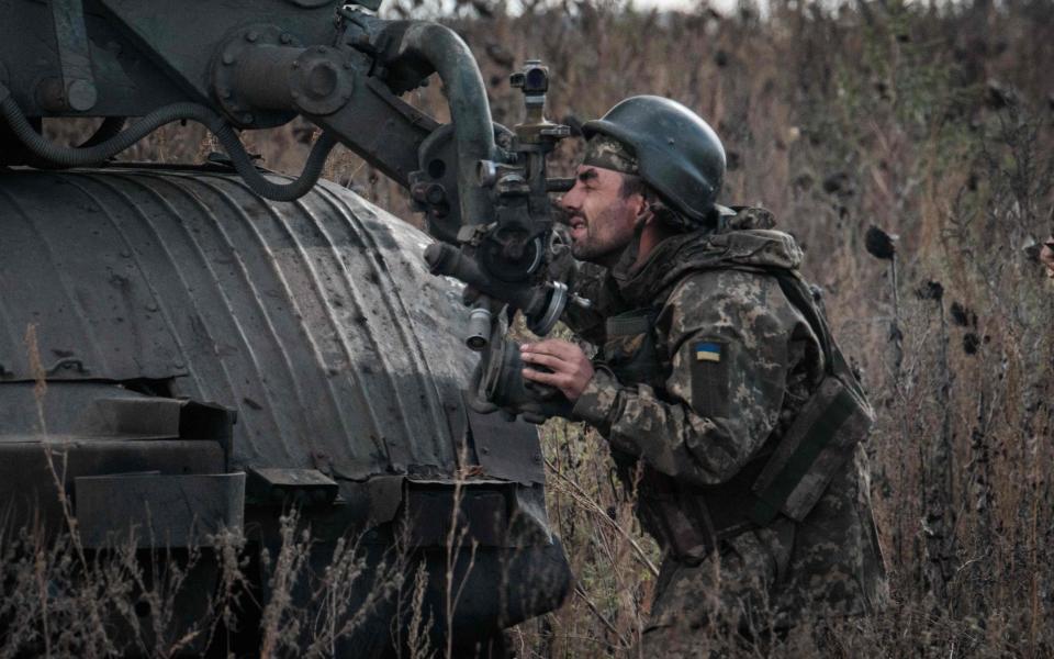 Ukrainian soldiers prepare to fire a BM-21 'Grad' multiple rocket launcher towards Russian positions in Kharkiv region - AFP