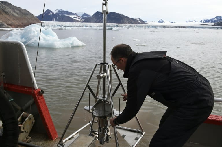 French oceanographer Philippe Kerherve takes samples from the Kongsfjorden fjord near the scientific base of Ny-Alesund on July 21, 2015