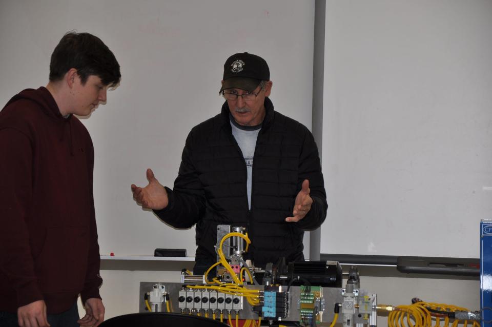West Branch High School junior Bobby Libert, 17, talks to Larry Starcher, the grandfather of junior Aiden Hurles, a classmate of Libert's in the school's Industrial Maintenance program. The school launched the program last fall and there are 21 students involved in it.
