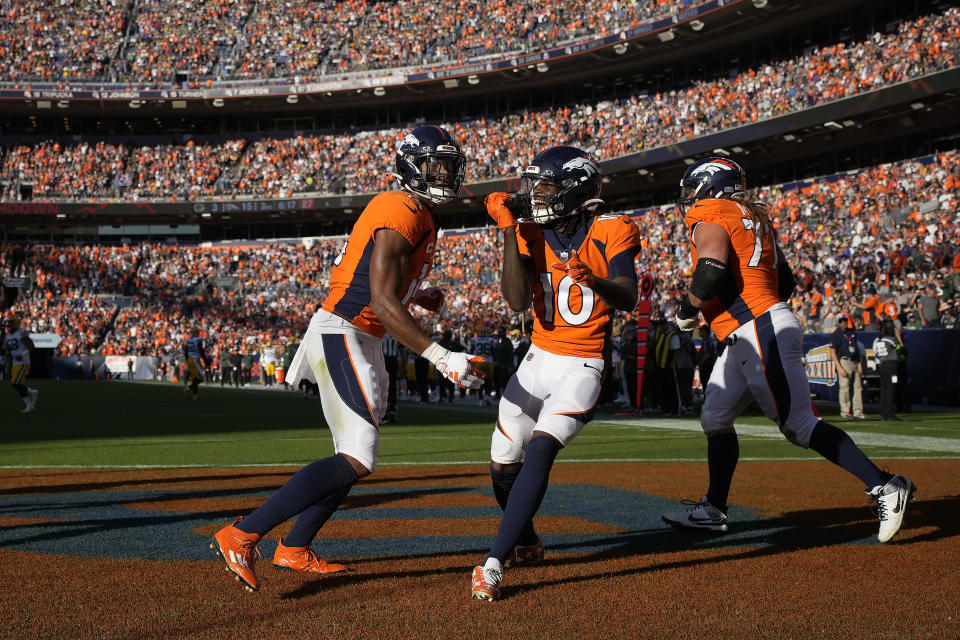 Denver Broncos wide receiver Courtland Sutton, left, celebrates after scoring a touchdown with wide receiver Jerry Jeudy (10) and guard Quinn Meinerz during the second half of an NFL football game against the Green Bay Packers in Denver, Sunday, Oct. 22, 2023. (AP Photo/David Zalubowski)