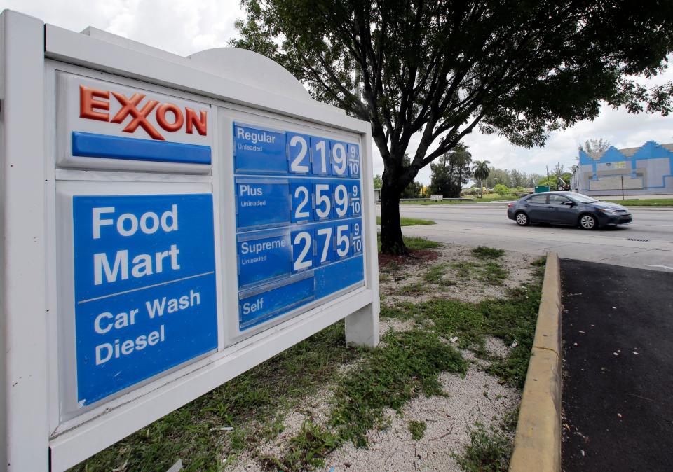 A motorist drives by an Exxon sign displaying gas prices in Opa-locka, Fla., on July 19, 2017.
